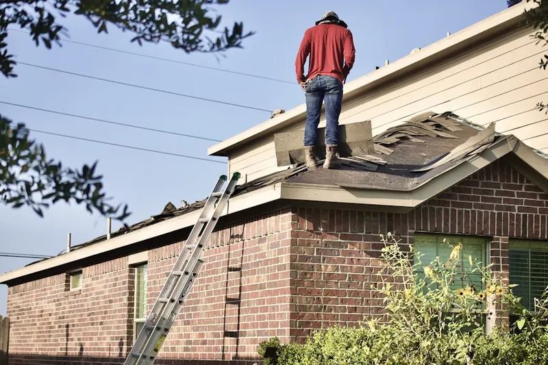 Professional roofer working on a residential roof in Coachella